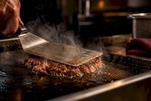 Carne prensada sobre plancha caliente
